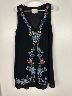 The Cove black boho dress features heavy floral embroidery and v-neckline small